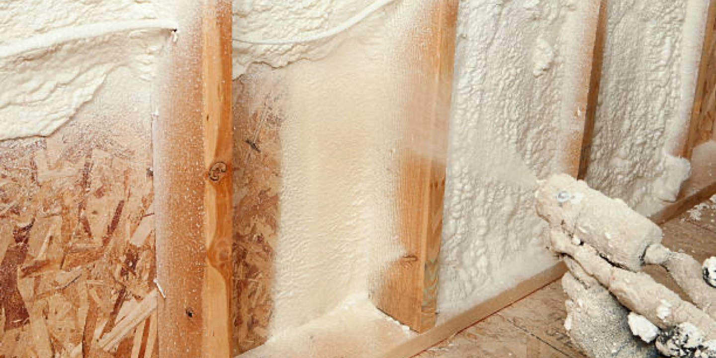 spraying in foam insulation within the framing of a wall, Revise Inc